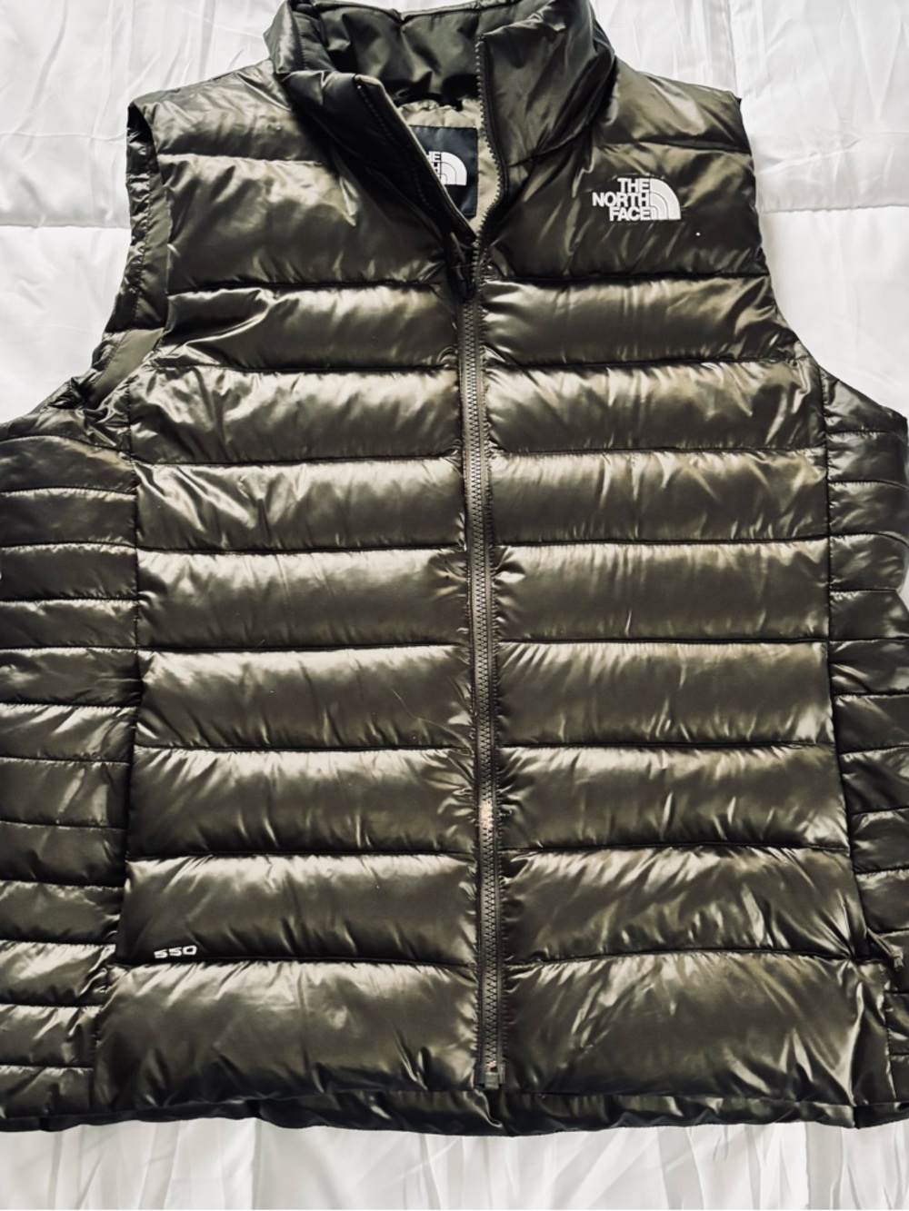 The North Face dark green puffer vest with white logo